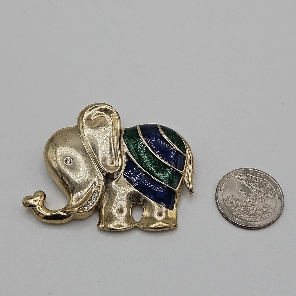 gold tone elephant pin with rhinestones and blue and green enamel